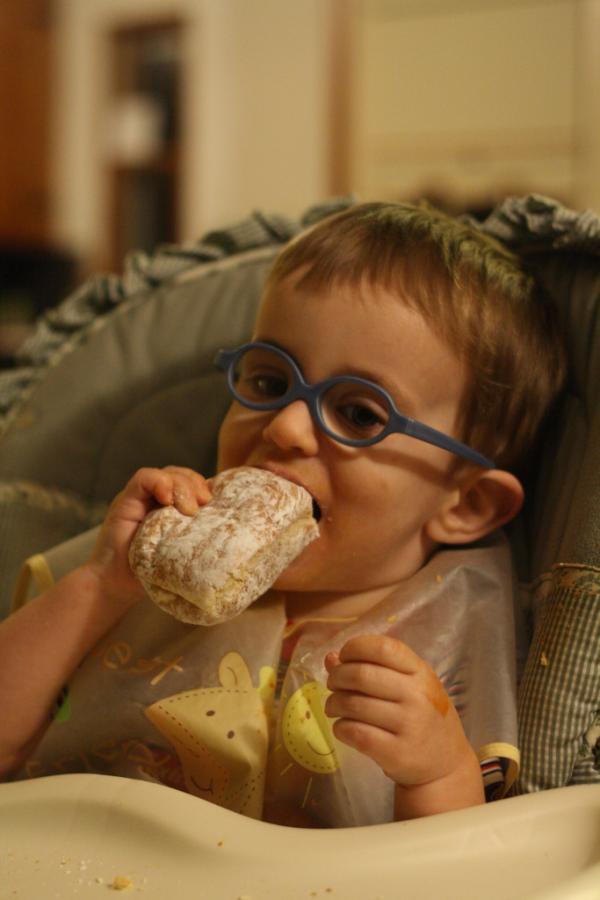 David eating a celebratory donut at home.